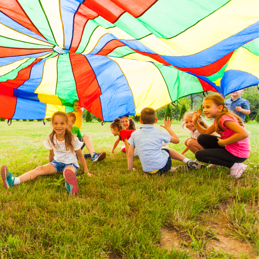 Summer camp kids playing parachute game at Mountain Magic Camp